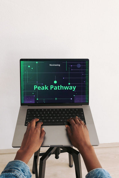 Person using a laptop with 'Peak Pathway' displayed on the screen