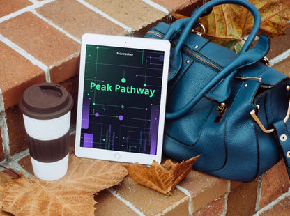 Blue handbag, tablet displaying  and coffee cup on a brick surface with leaves.